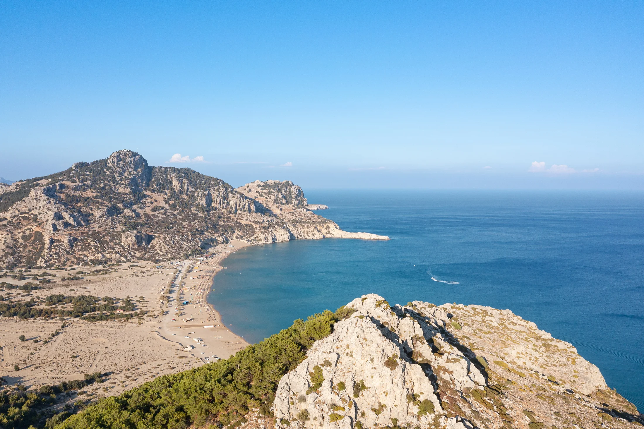 Sand, clear water and the rocky headland